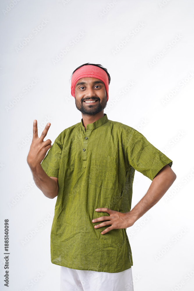 Naklejka premium happy young indian farmer standing on white background