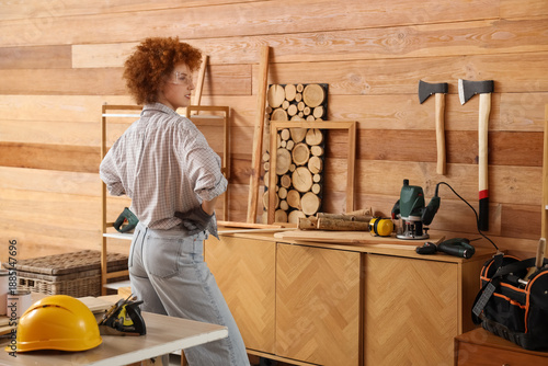 Young female carpenter with...