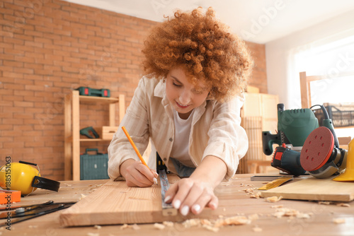 Young female carpenter with...
