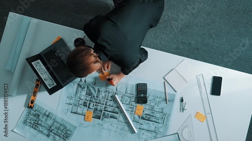 Top view of manager using ruler to measure project plan while looking at building construction on laptop screen. Aerial view architect engineer analyzing and planning about structure. Alimentation.