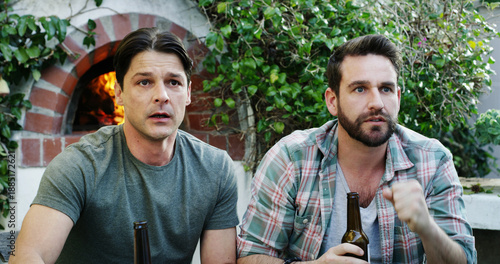Photography Television, suspense and friends outdoor with beers for movie, sports game or show in home