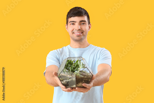 Young man with florarium on...