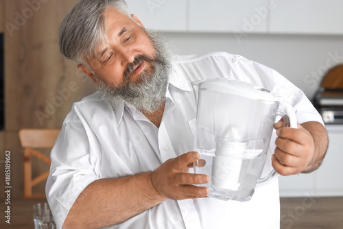 Mature man with water filte...