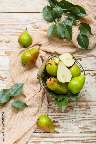 Basket with ripe pears on w...