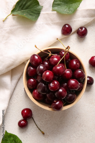 Bowl with sweet cherries on...