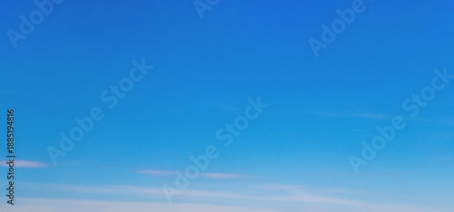 Photography Clear blue gradient sky background with soft transition from deep to light tones and scattered wispy clouds, offering a calm and minimalist visual atmosphere