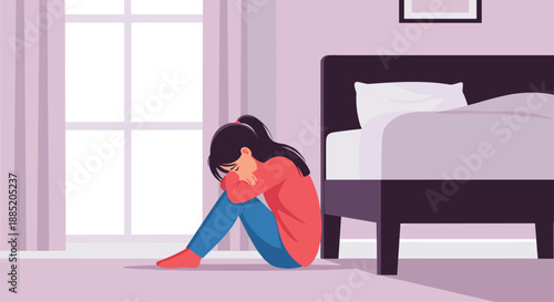 Depressed young woman sitting alone on the floor in a dark room, feeling sad, lonely, and anxious about her problems.