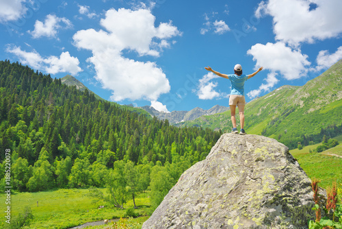 Woman enjoy mountian nature and spread your arms.