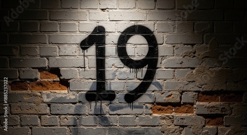 An old brick wall with a grunge texture features a graffiti digit 19 design as a street address figure on the urban stone architecture