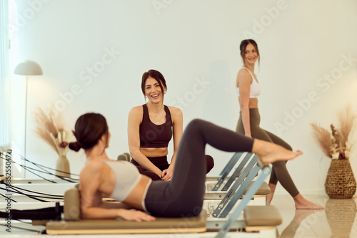 Wallpaper Mural Group Of Women Doing Pilates Reformer Workout In Bright Studio During Fitness Class Torontodigital.ca