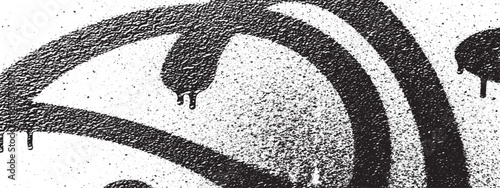 Black and white closeup of abstract graffiti art on a wall showcasing spray paint texture and drips.
