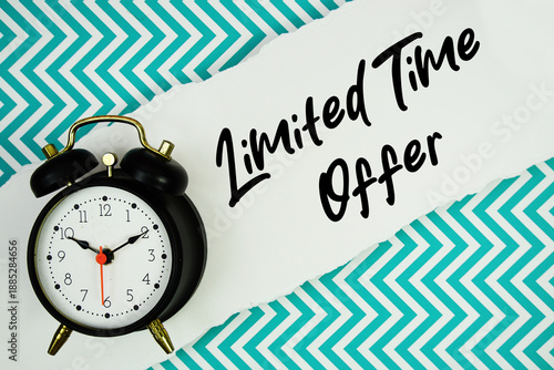 Limited Time Offer text written on paper rip with alarm clock flat lay on turquoise chevron background