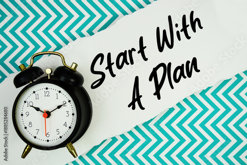 Start With A Plan text written on paper rip with alarm clock flat lay on turquoise chevron background