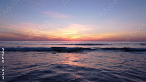 Wallpaper Mural A serene ocean sunset casts vibrant hues across the sky and water Gentle waves reflect the golden light creating a peaceful and breathtaking natural scene Torontodigital.ca