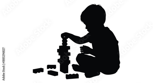 A young child is intently focused on building a tall colorful tower of blocks while sitting on the floor silhouette