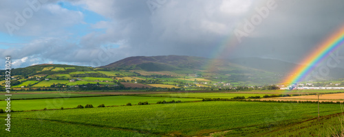 Fotografie Panorama of a vivid rainbow over Inch Levels with view to Scalp Mountain near Burnfoot, County Donegal in Ireland