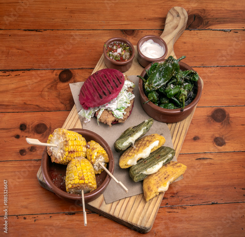 Wallpaper Mural mixed colombian and venezuelan snack food platter on wooden restaurant table Torontodigital.ca