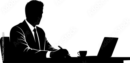 Dedicated man concentrates intently on his professional work using a laptop at a desk lit by a bright task lamp.