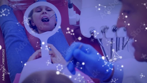 Animation of molecules and purple tint over patient in dentist chair and male dentist