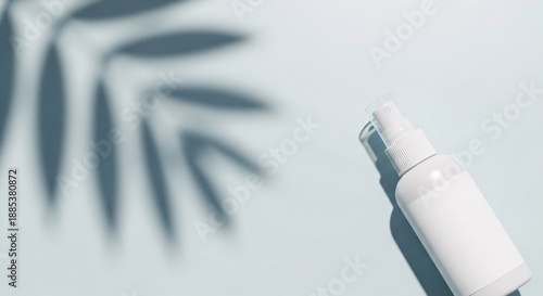 White cosmetic spray bottle Mockup with tropical leaf shadow with copy space