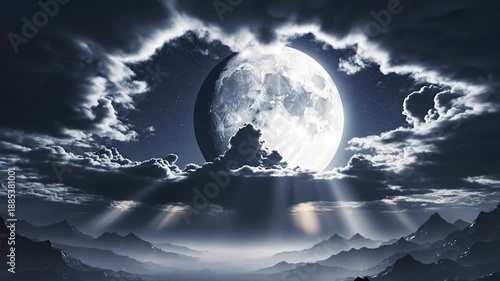 Bright full moon through stormy clouds, casting light beams over misty mountain peaks