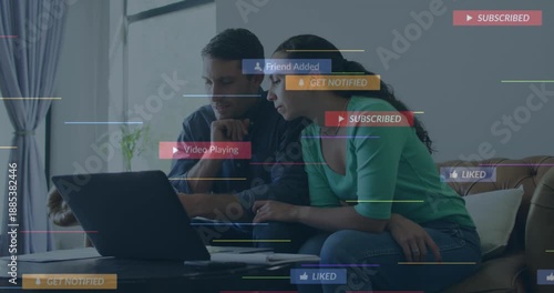 A young couple is talking and paying their bills using a laptop