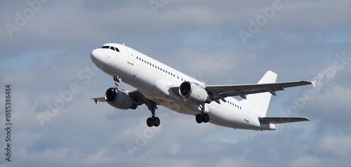 Airplane take off on the blue sky, with white clouds. Aircraft flying on sky background. White passenger jet plane in the blue sky. Low angle view of Airplane flying under blue sky, with white clouds