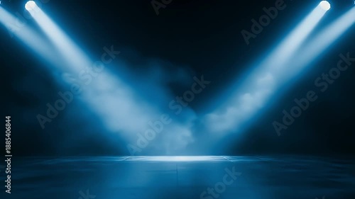 A dynamic stage scene unfolds in a dark, atmospheric setting, illuminated by two powerful blue spotlights. Wisps of smoke or fog drift lazily through the intense beams of light, creating an ethereal a