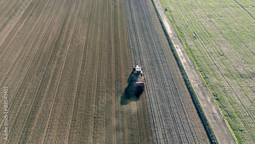 Top-down view of ploughing tractor on farmland