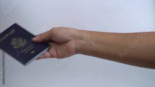 Hands holding and presenting a passport for travel, symbolizing international journey, border control, identification, immigration process, and global mobility.