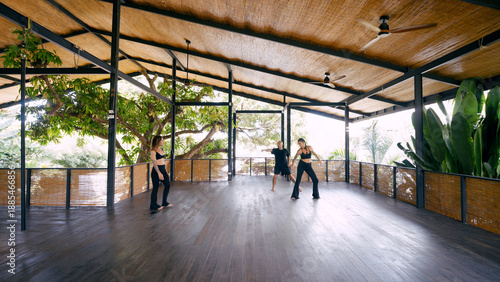 Fotografie Small group of dancers rehearsing contemporary movement in an open air studio, s