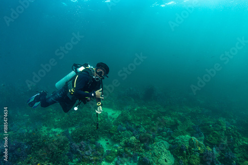 Fotografía Diver explores coral reef while using underwater equipment in tropical ocean env