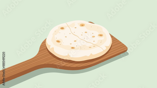 A warm, flatbread is presented on a rustic wooden serving tool