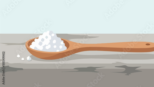 A wooden spoon filled with white granular material rests on a surface