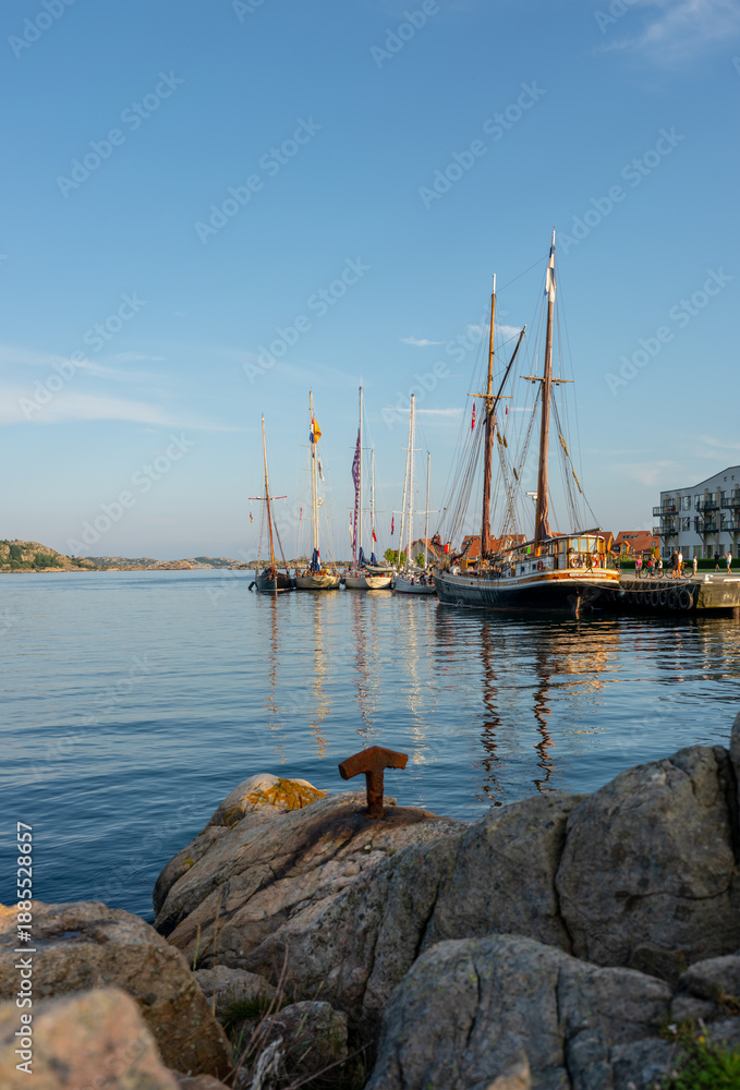 Fototapeta premium Lindesnes, Norway - July 24 2025: Panoramic view of sailboats docked in harbor.
