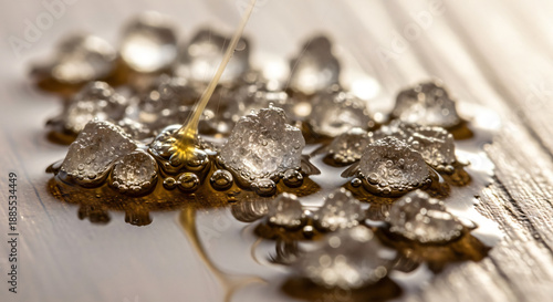 Wallpaper Mural Macro shot of melting ice and golden syrup on a wooden table Torontodigital.ca