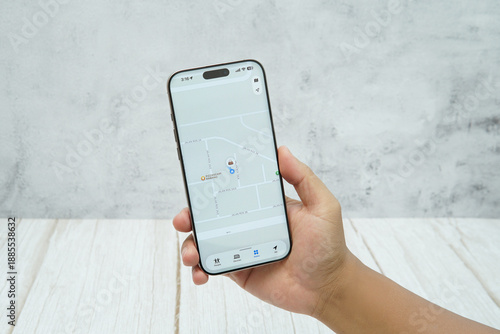 Wallpaper Mural Hand holding smartphone displaying generic tracking application interface. Concept of location tracking, activity monitoring, and mobile technology for business and personal use. Torontodigital.ca