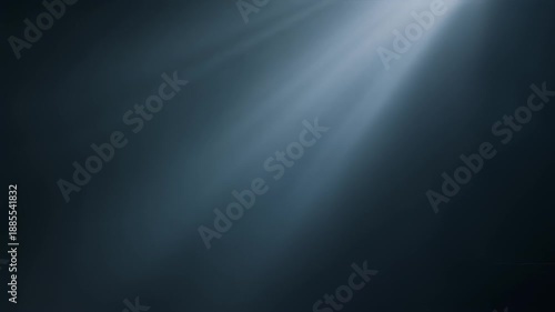 A dark, moody image featuring beams of light emanating from an upper right corner, creating a striking contrast