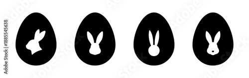 Set of four black Easter egg silhouettes with white rabbit cutouts. Vector illustration of bunny shapes inside egg icons.