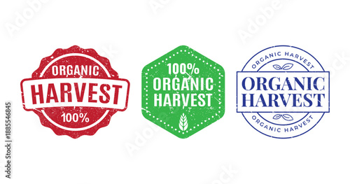 Three colorful vintage style badges for one hundred percent organic harvest products with distressed grunge texture