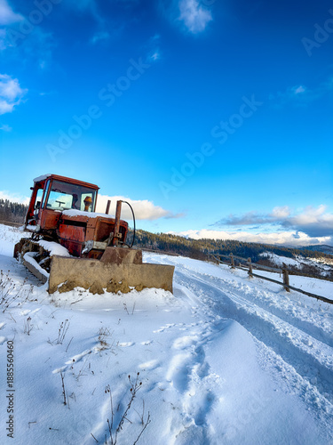Mystical snowy Carpathian peaks under cloudy skies in the sunny weather