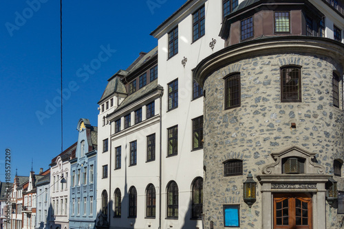Historic Ålesund Street View with Rough-Hewn Stone Tower and Colorful Art Nouveau Facades