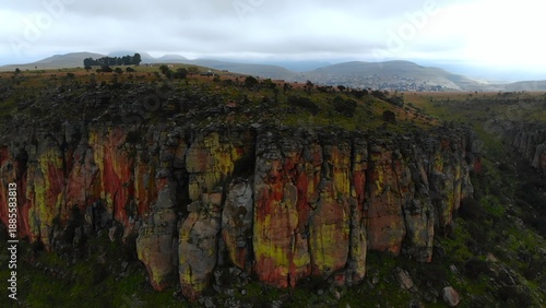 Photography colorful rugged shoreline, vivid crusty cliffs adorned with orange moss and moss