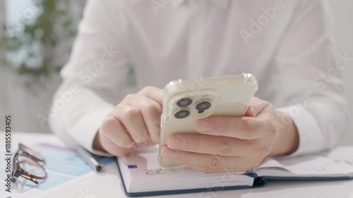 Businessman Typing On Smartphone During Desk Work