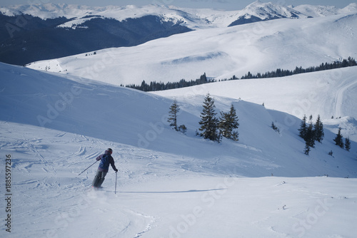 Ski touring skier in Bucegi Mountains on a beautiful winter sunny day
