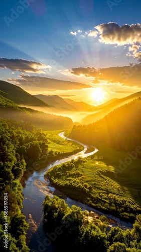 Serene river winding through a lush green valley with mountains bathed in the warm golden light of the setting sun.
