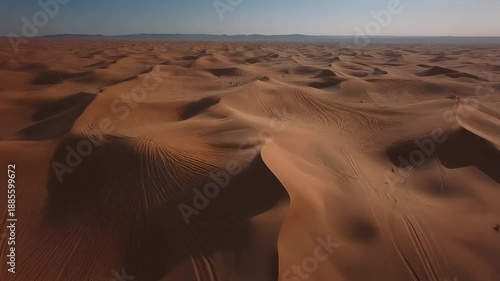 Aerial view of a vast desert landscape with sand dunes