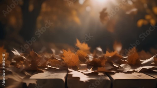 Golden leaves float gently down onto a wooden surface in an artistic, blurred close-up shot, evoking autumn's soft beauty