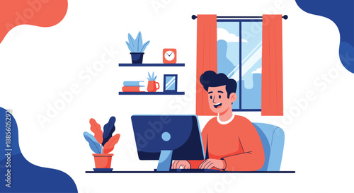 Happy young man working on his desktop computer at home in a cozy room with shelves and a bright window view.