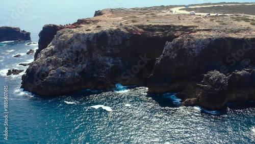 Canvas-taulu jagged precipice overlooking turbulent waters below, steep rocky outcrop with tr